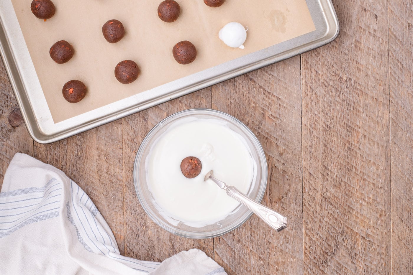 dipping carrot cake balls in white chocolate