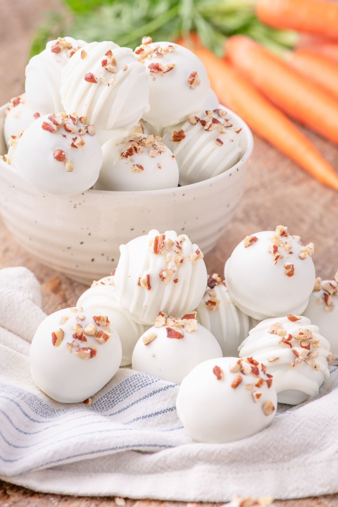 Carrot Cake Truffles in a bowl and resting on a towel
