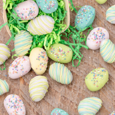 Close up photo of Easter Egg Oreo Truffles falling out of an Easter basket