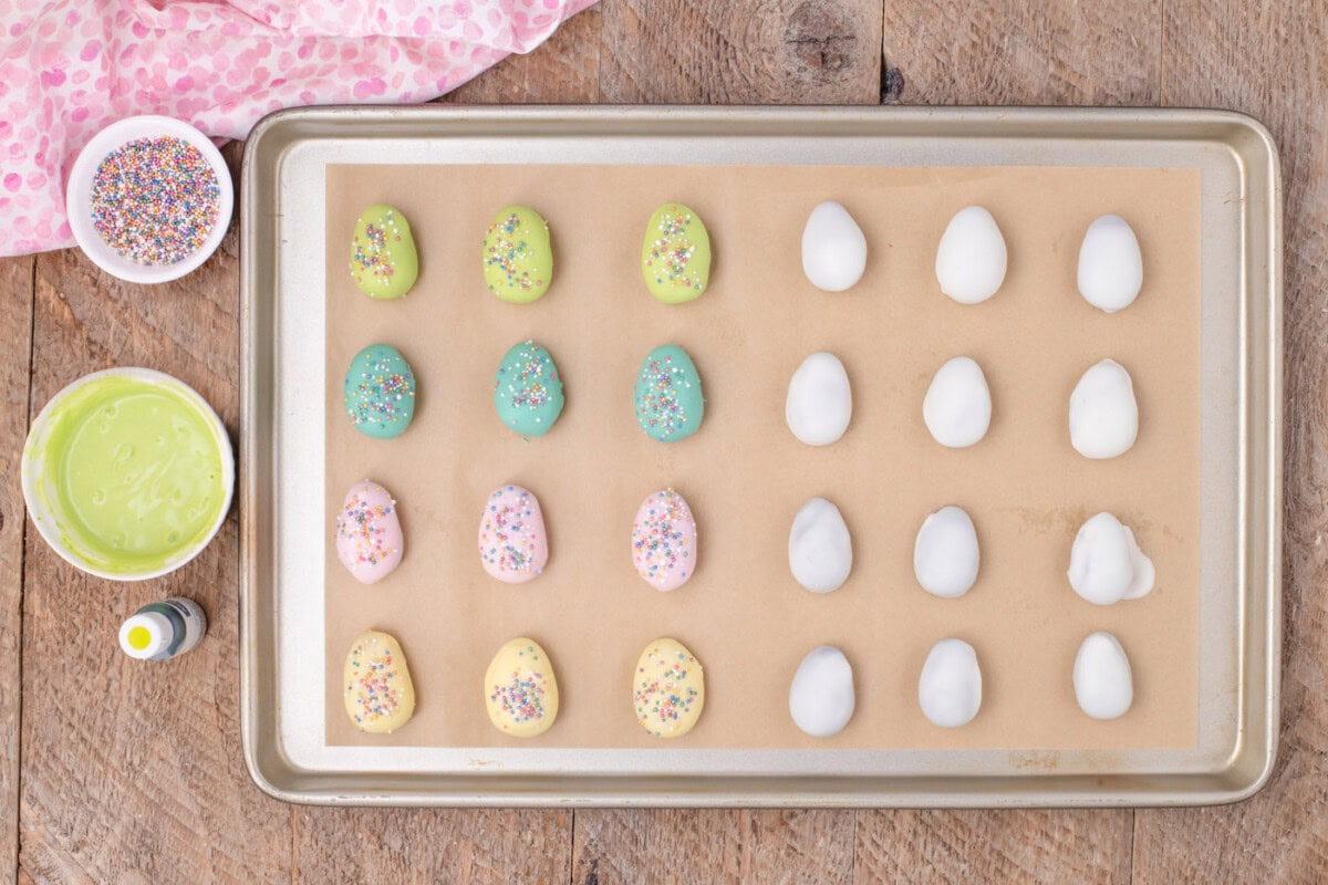 pastel colored Oreo truffles on a baking sheet with sprinkles