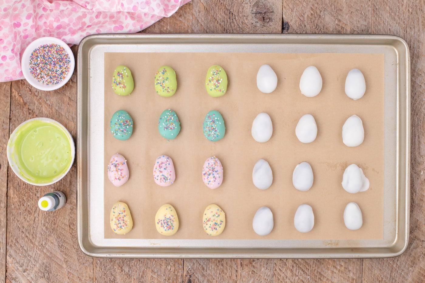 pastel colored Oreo truffles on a baking sheet with sprinkles
