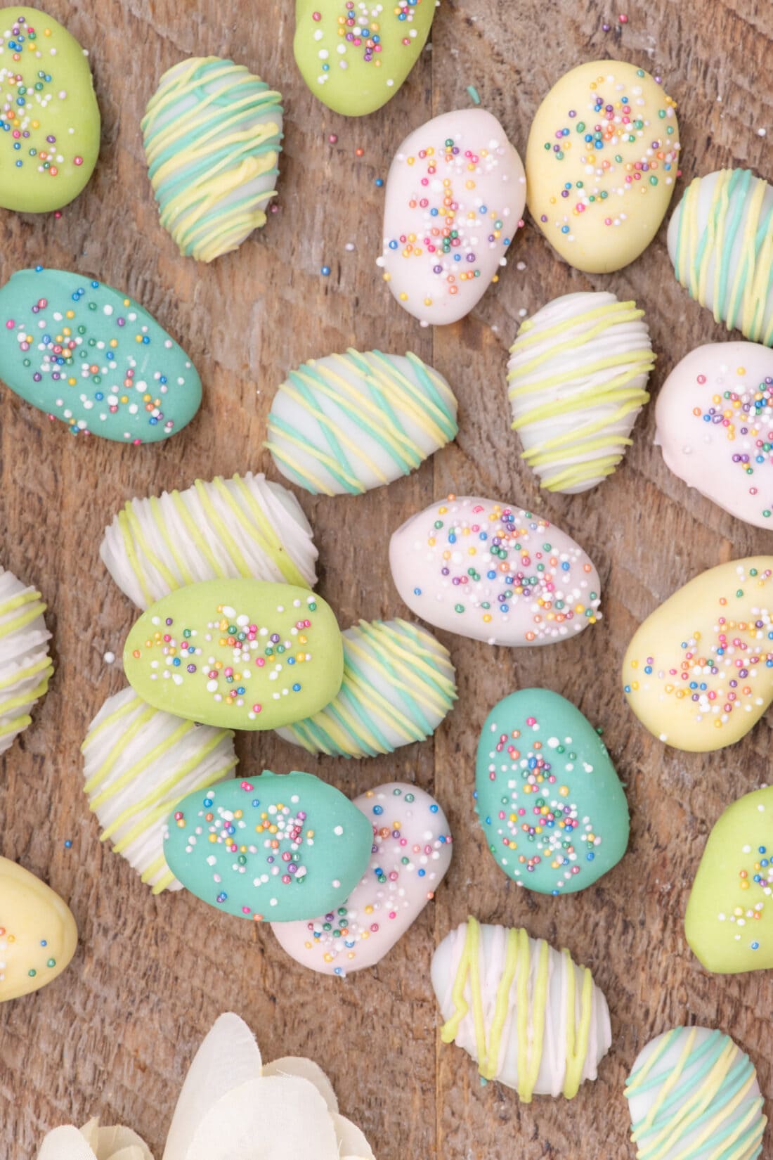 Assorted Easter Egg Oreo Truffles on a wooden board