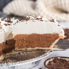 Slice of French Silk Pie being lifted up by a pie server
