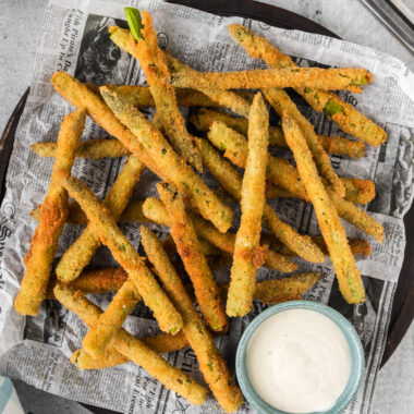 Fried Asparagus on a platter with a bowl of ranch