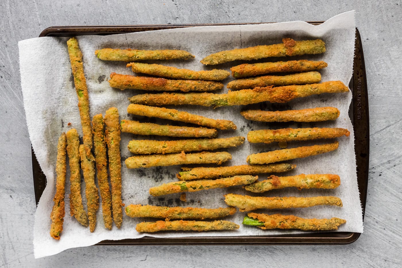 fried asparagus draining on paper towels