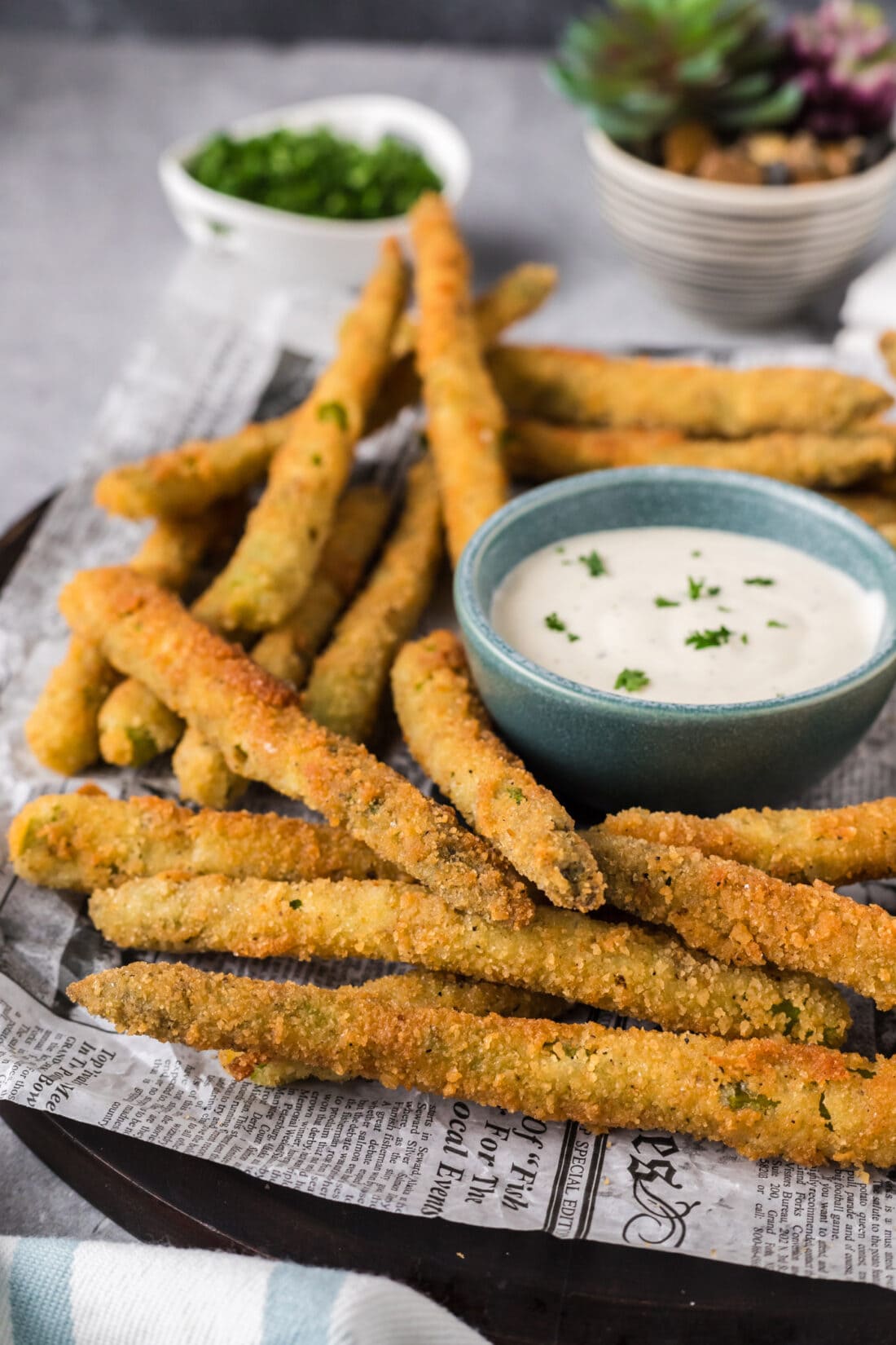 Fried Asparagus on a plate with ranch for dipping in a bowl
