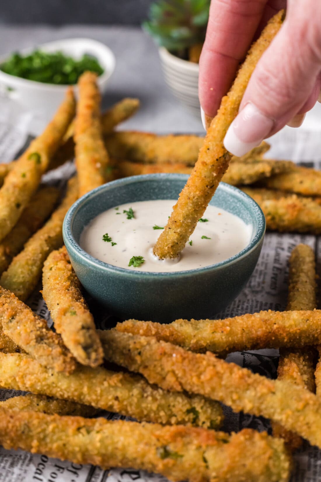 Fried Asparagus being dipped into ranch