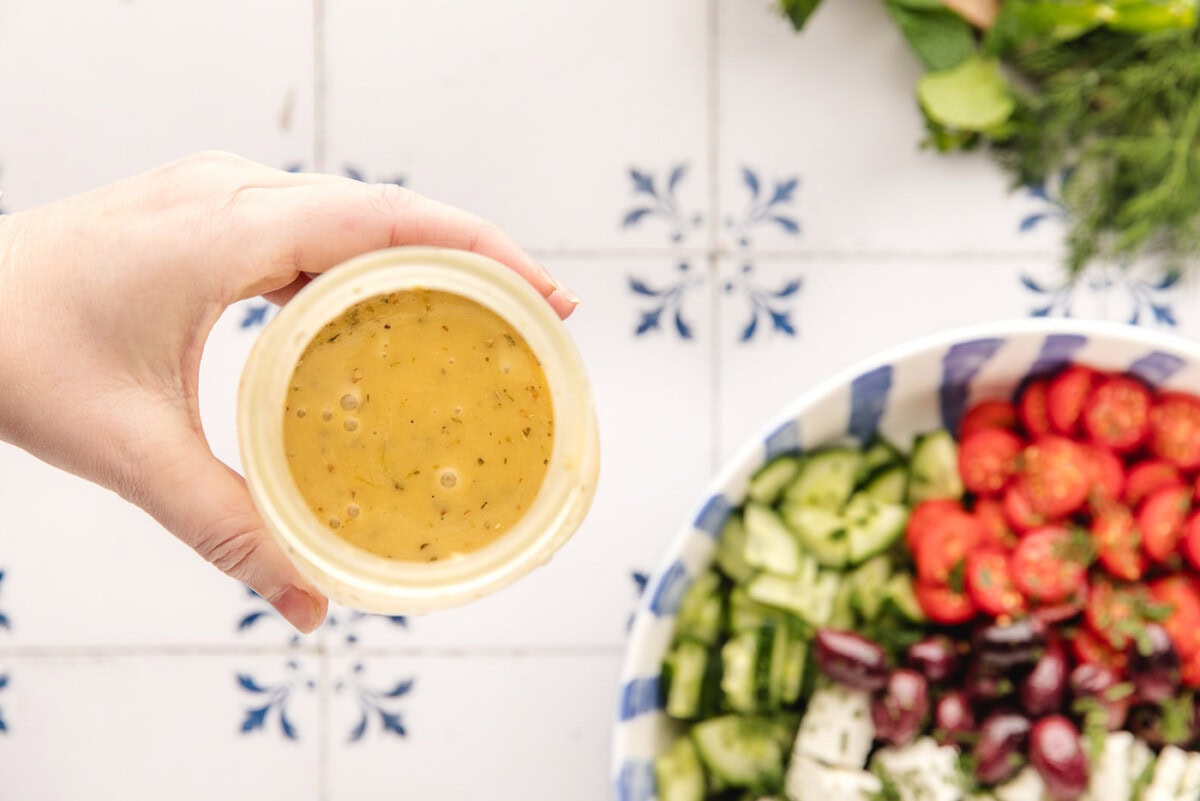 blended Greek salad dressing in a jar