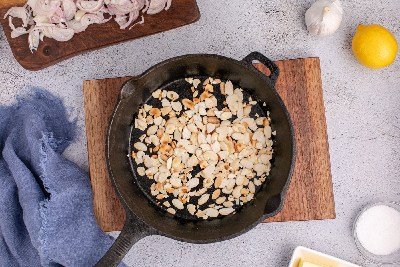 toasting sliced almonds in a skillet
