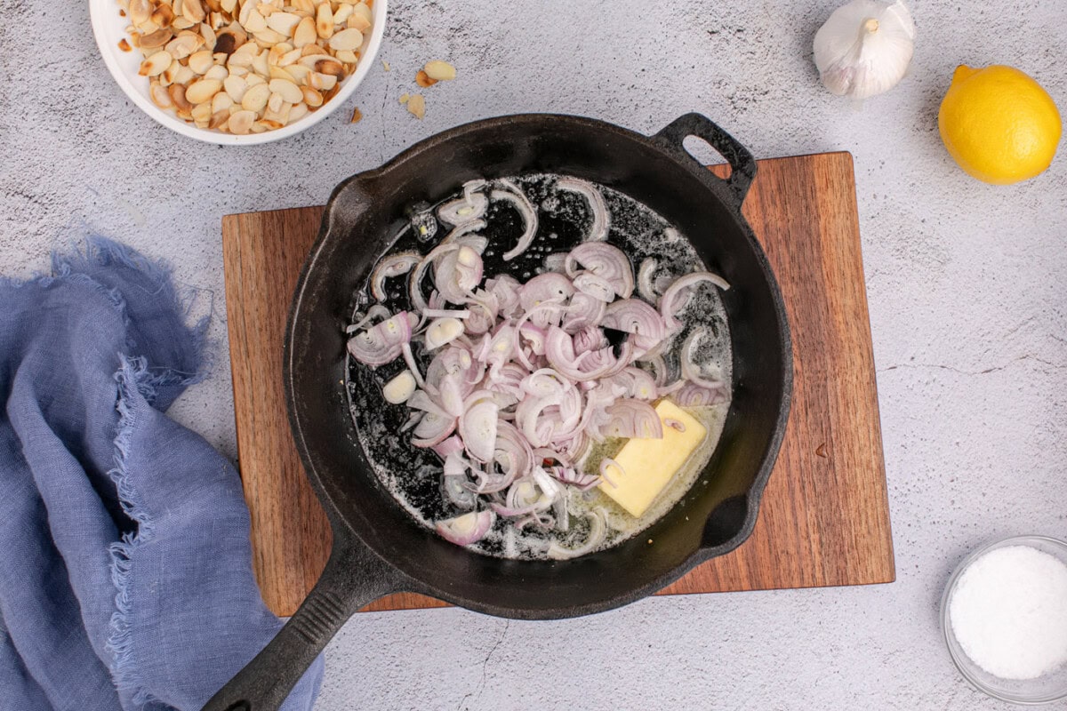 shallots added to butter in a skillet