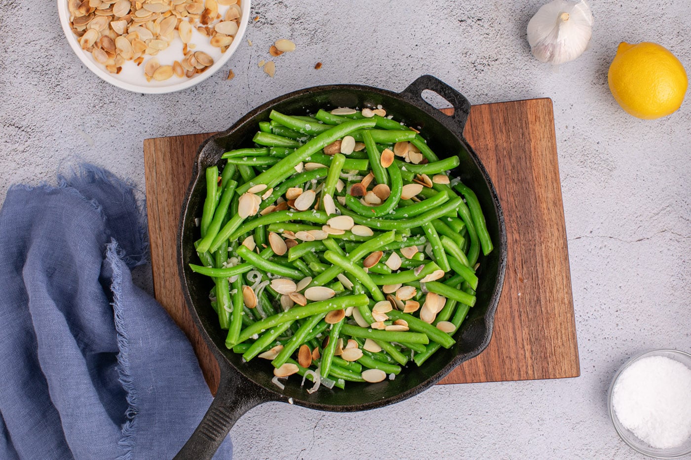 toasted almonds added to green beans in skillet