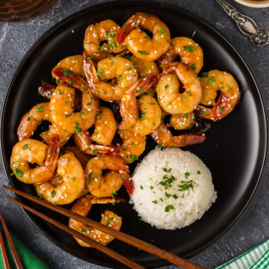 Honey Garlic Shrimp on a plate with rice and chopsticks