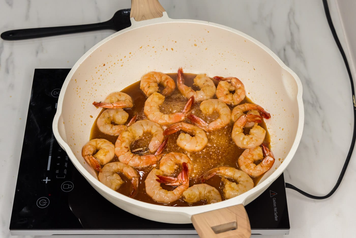 cooked shrimp in skillet with honey garlic sauce