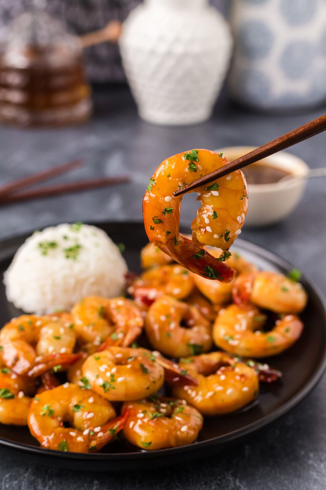 Honey Garlic Shrimp held up by chopsticks 