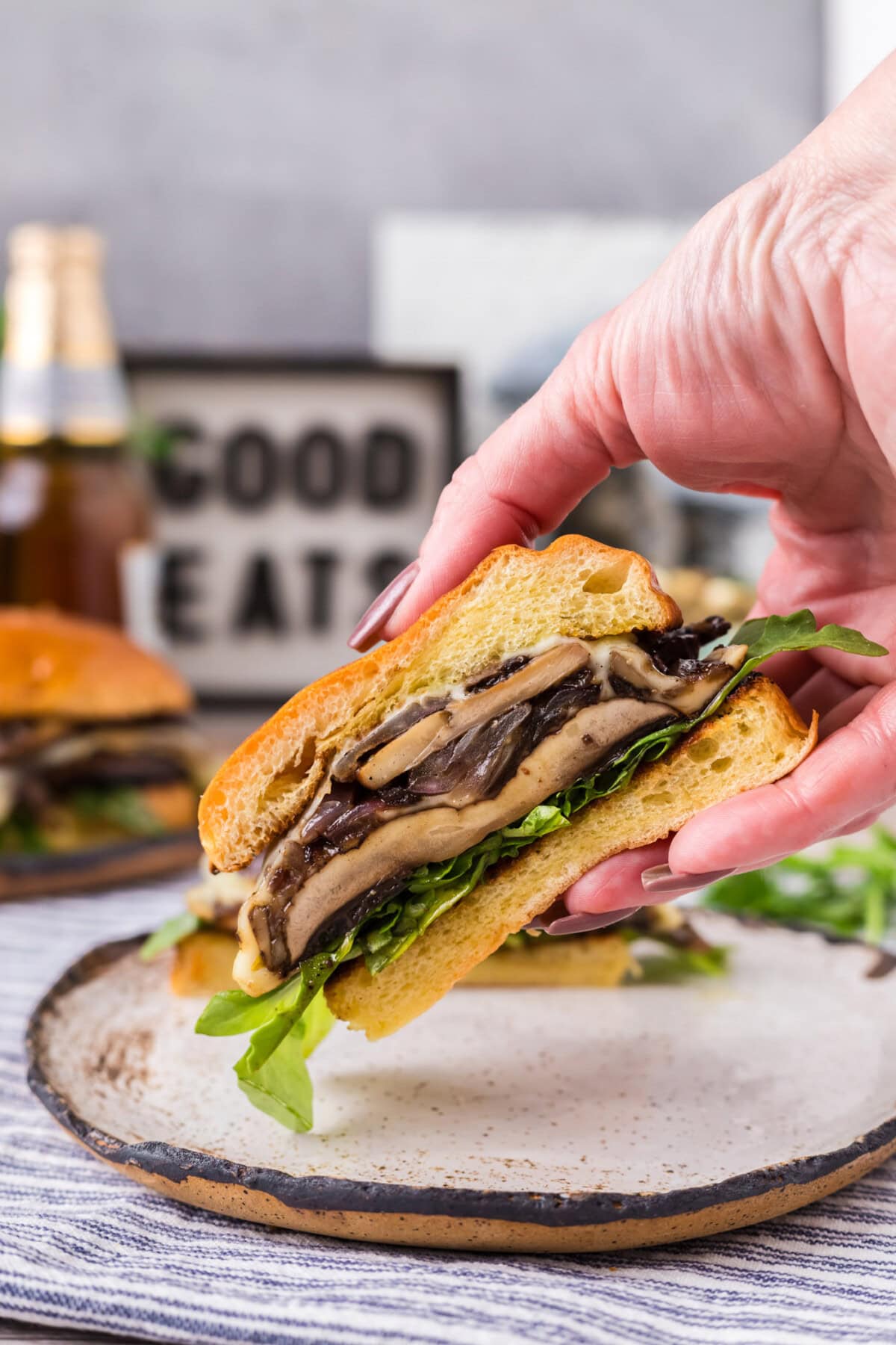 Hand holding up half of a Mushroom Burger