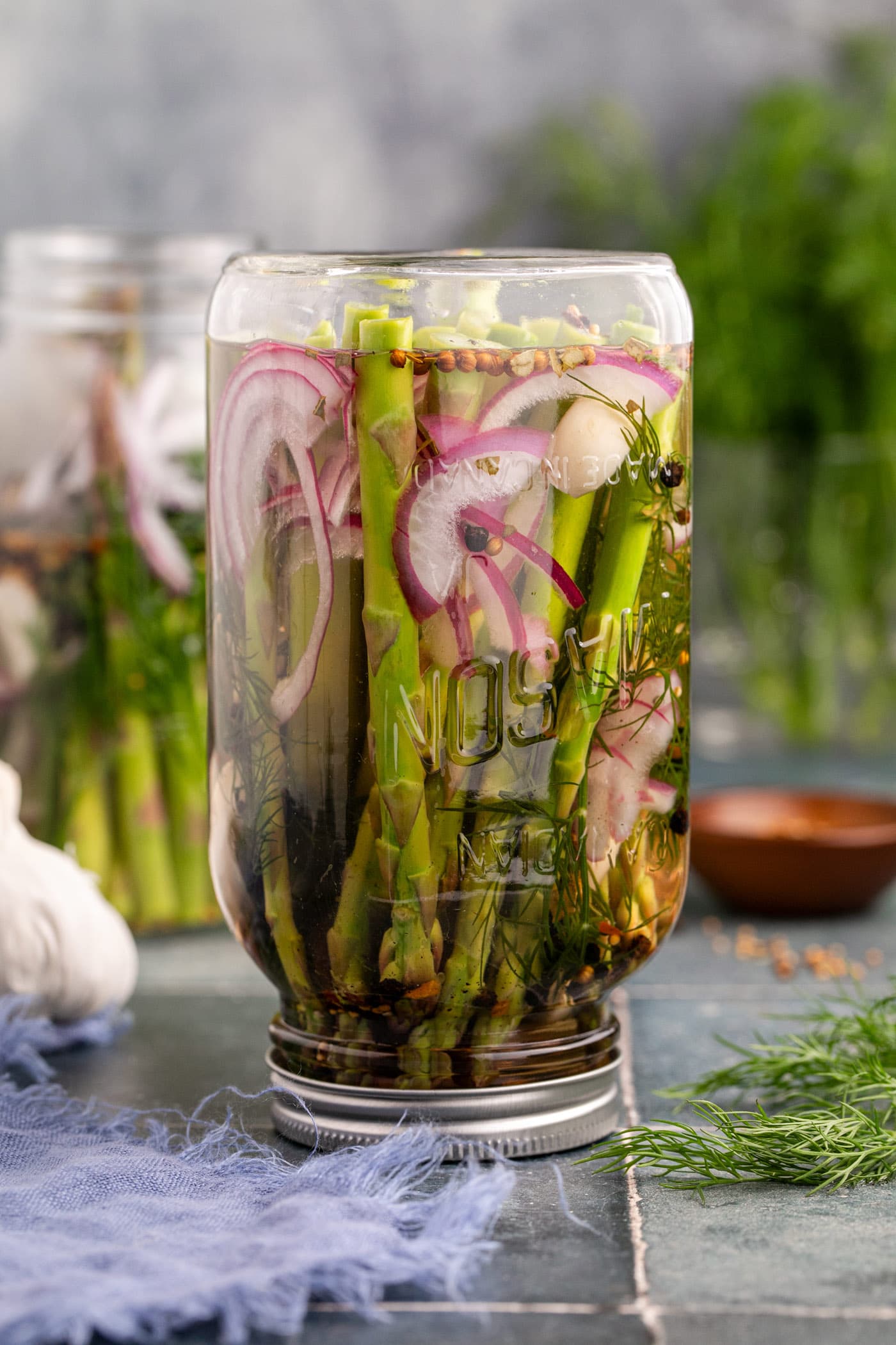 pickled asparagus upside down in a mason jar