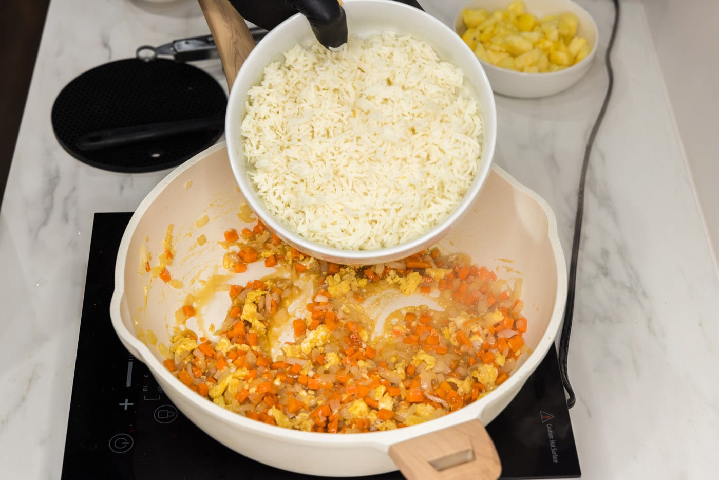 cooked rice added to pan of stir fried veggies and egg