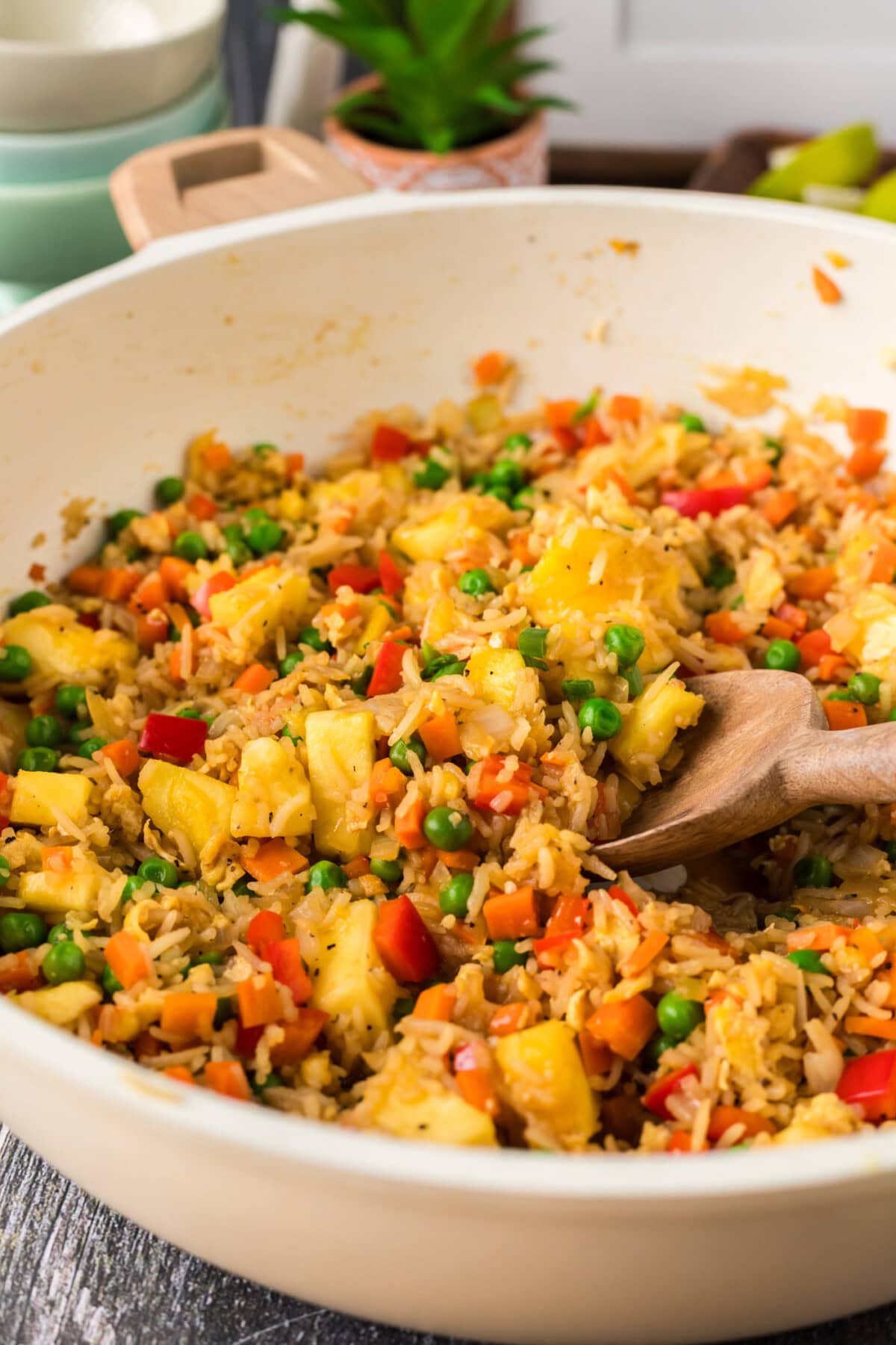 Close up photo of Pineapple Fried Rice in a skillet with a spoon