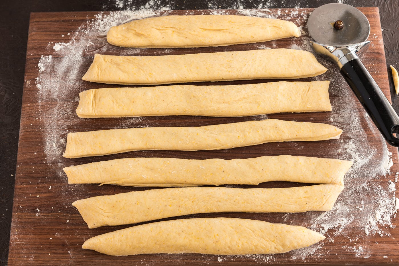 cutting strips of dough for dinner rolls