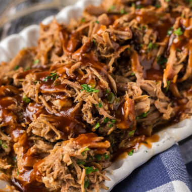 Close up photo of Pulled Pork with barbecue sauce drizzled on top
