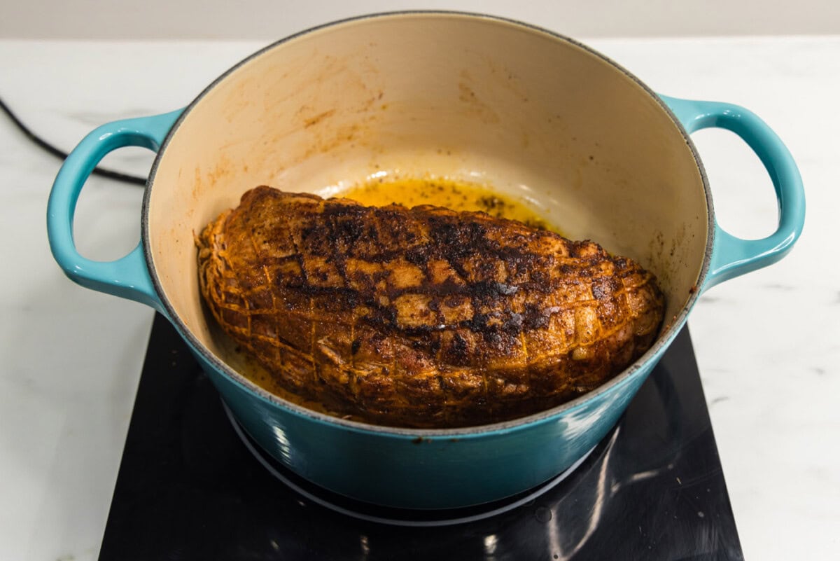seared pork shoulder in a dutch oven