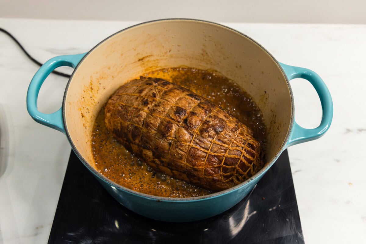 pork shoulder in a dutch oven with dr pepper