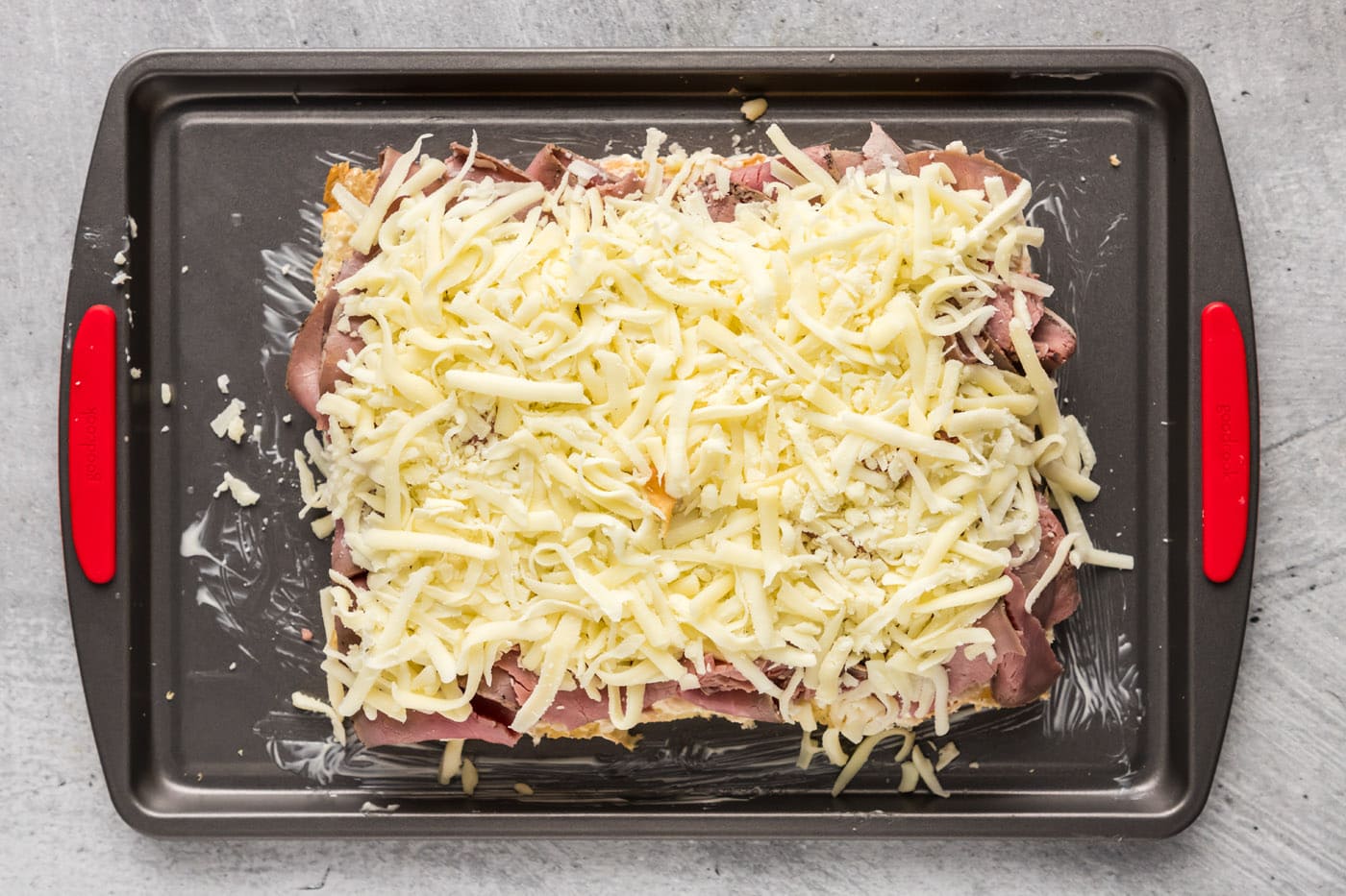 shredded mozzarella cheese over roast beef sliders