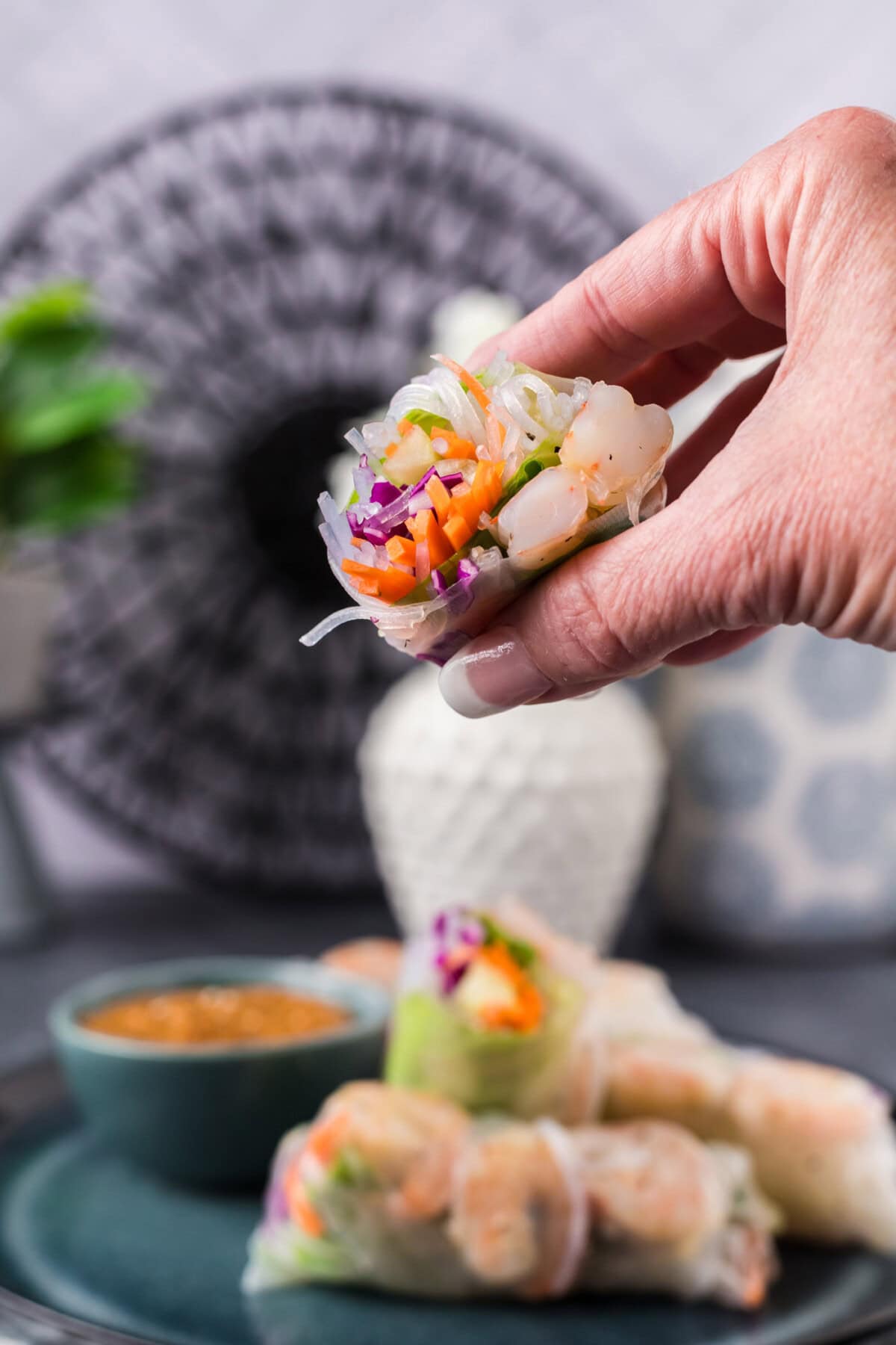 Hand holding half a Shrimp Spring Roll