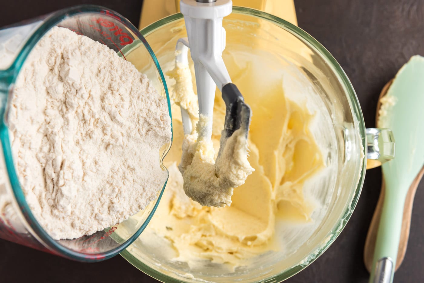 adding dry ingredients to wet ingredients in a stand mixer