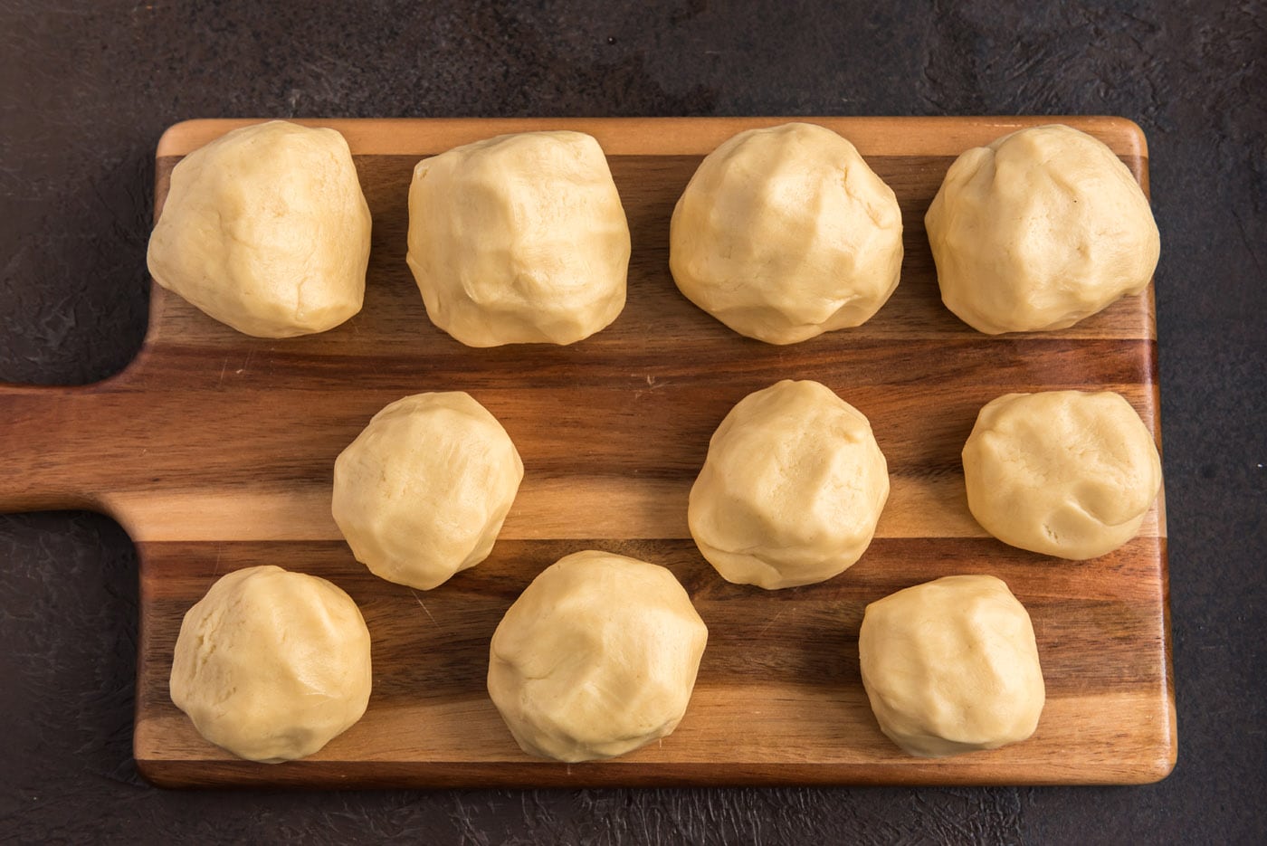 sugar cookie dough balls on a cutting board