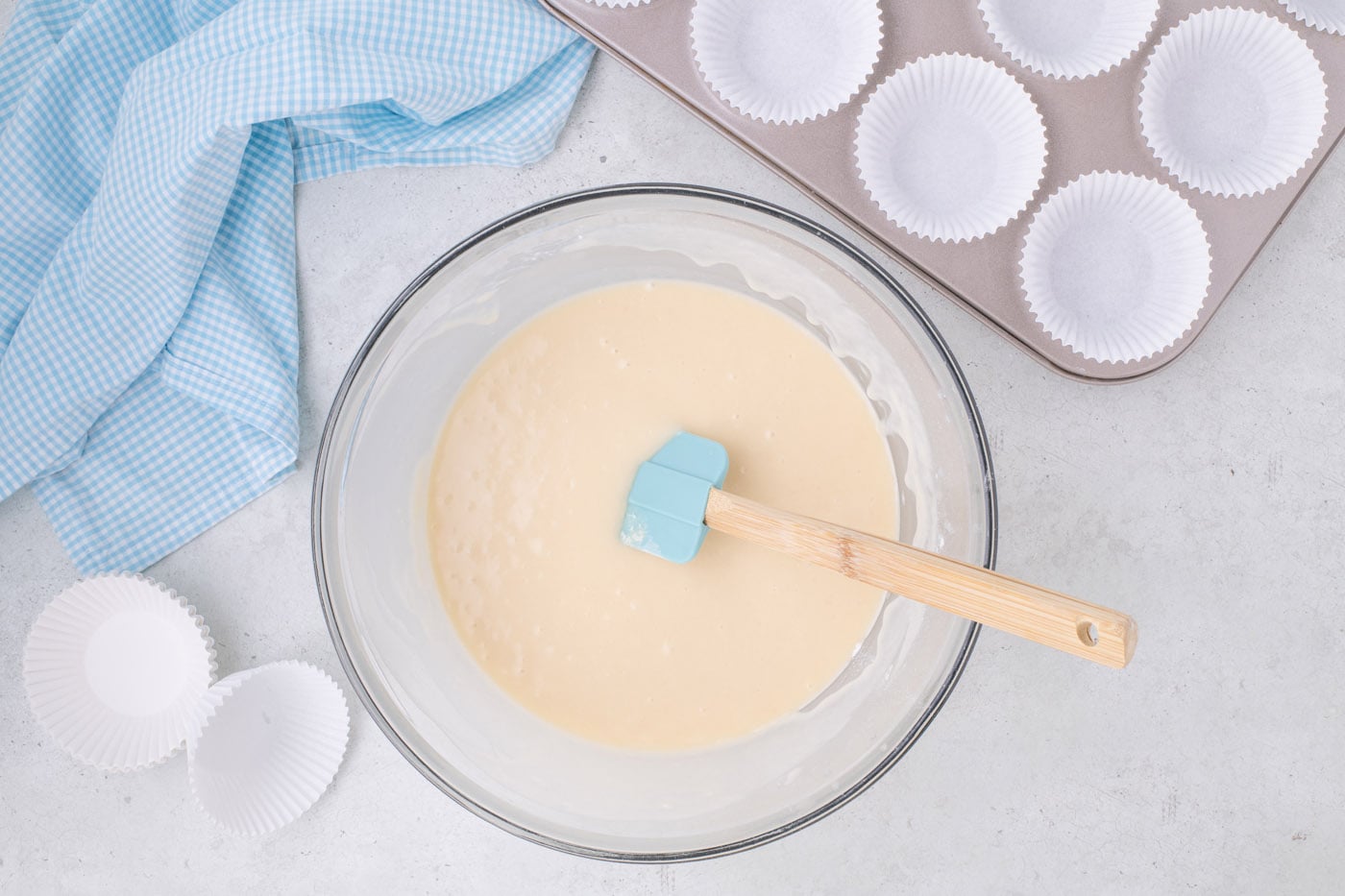 rubber spatula in a bowl of vanilla cupcake batter