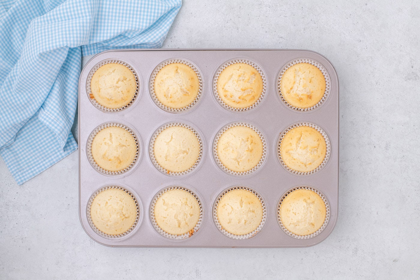 baked vanilla cupcakes in a muffin pan