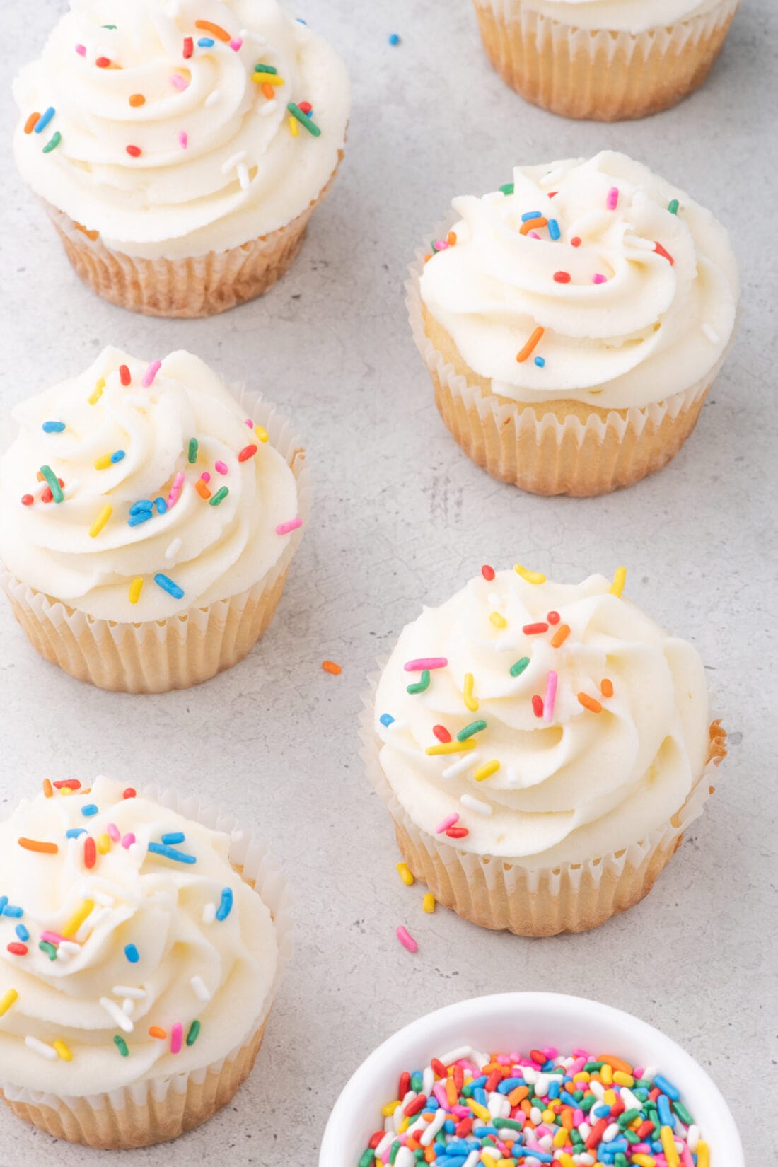 Vanilla Cupcakes topped with rainbow sprinkles