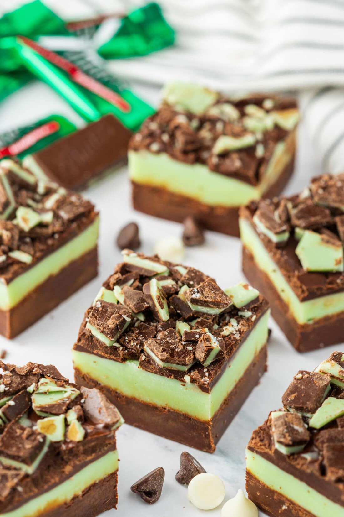 Andes Mint Fudge on a table with mints in the background