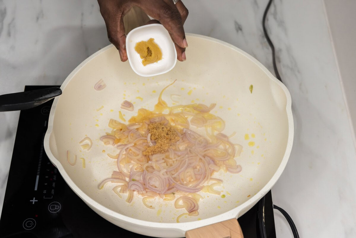 adding minced ginger to skillet of garlic and shallots