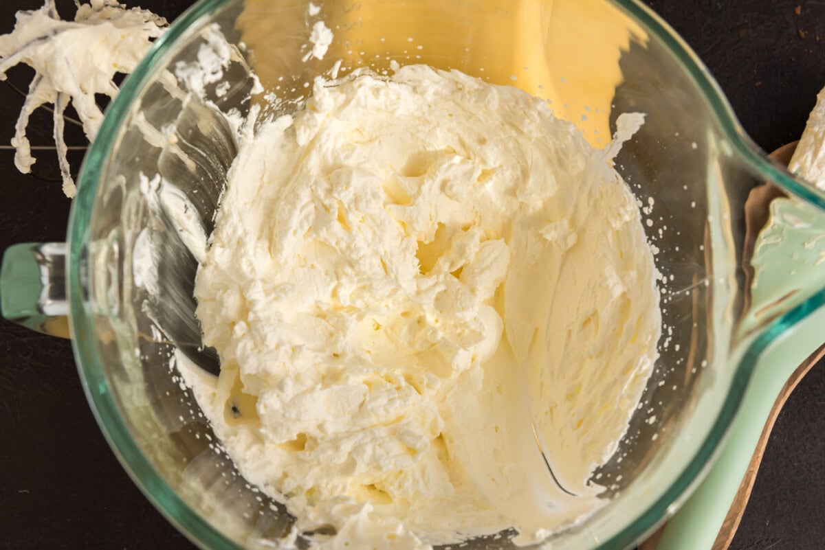 heavy whipping cream beaten in a bowl