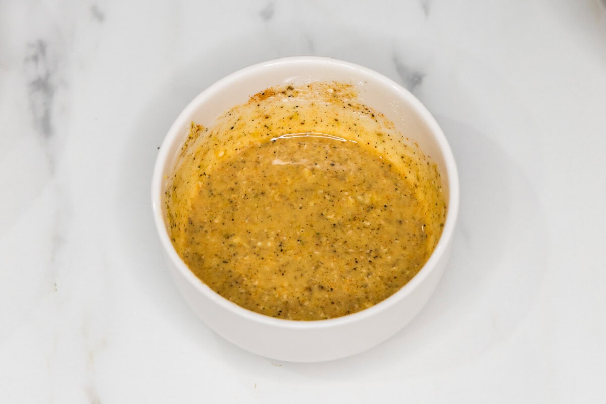 melted butter with old bay, lemon pepper, and garlic salt in a bowl