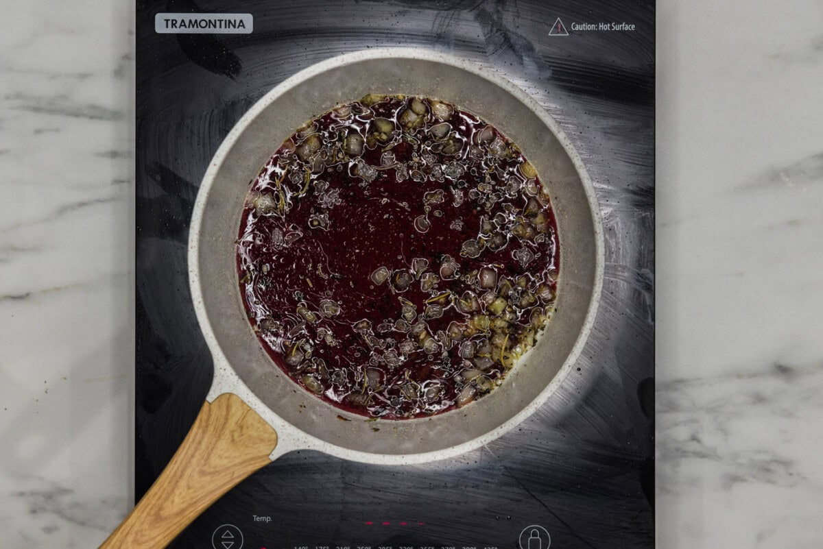 red wine added to skillet of onion and seasonings