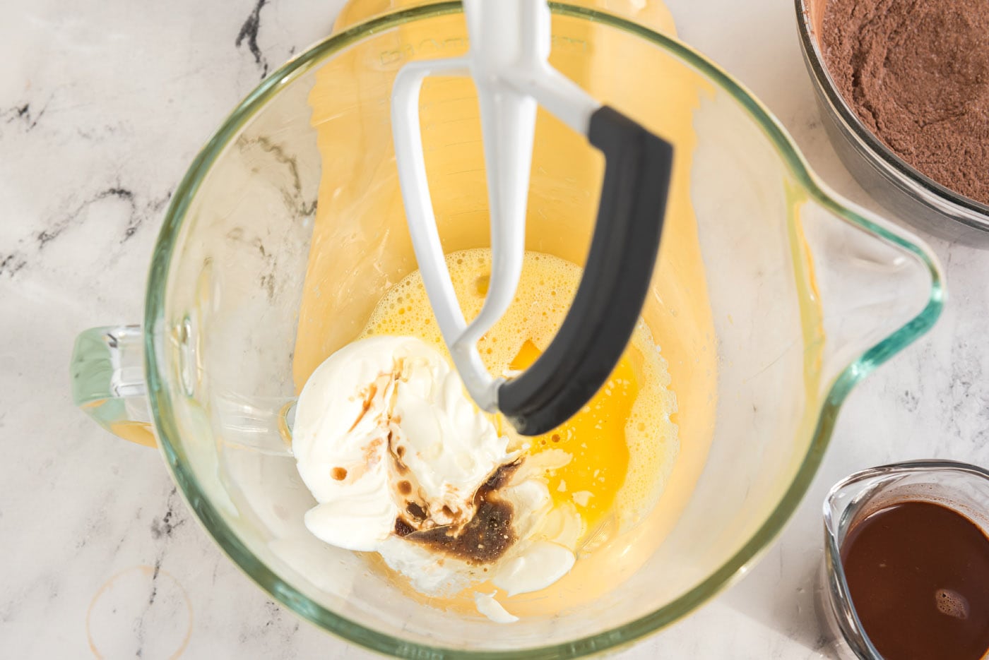 adding sour cream to egg mixture in a stand mixer