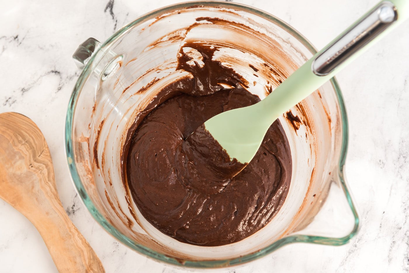 rubber spatula stirring dark chocolate cake batter