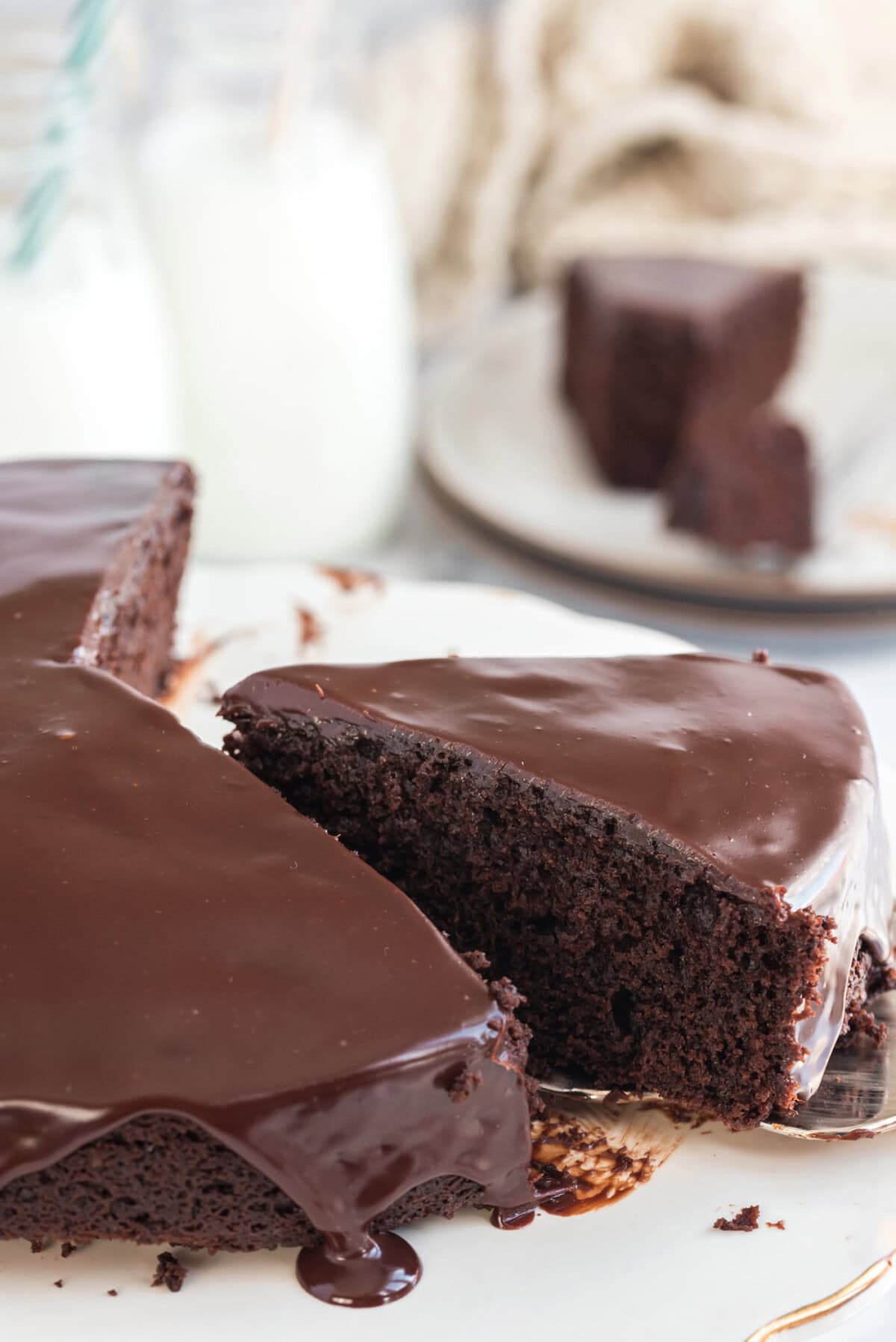 Dark Chocolate Cake on a cake stand with slices removed