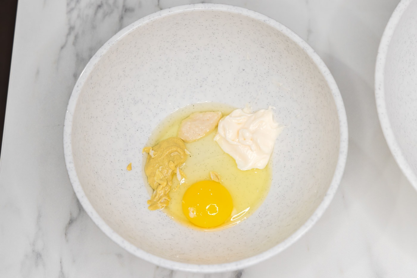 egg, horseradish, mayonnaise, and Dijon mustard in a bowl