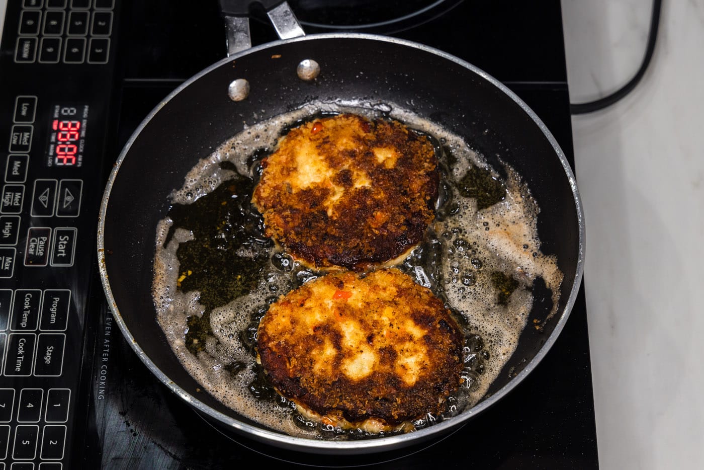 fried fish burgers in a skillet