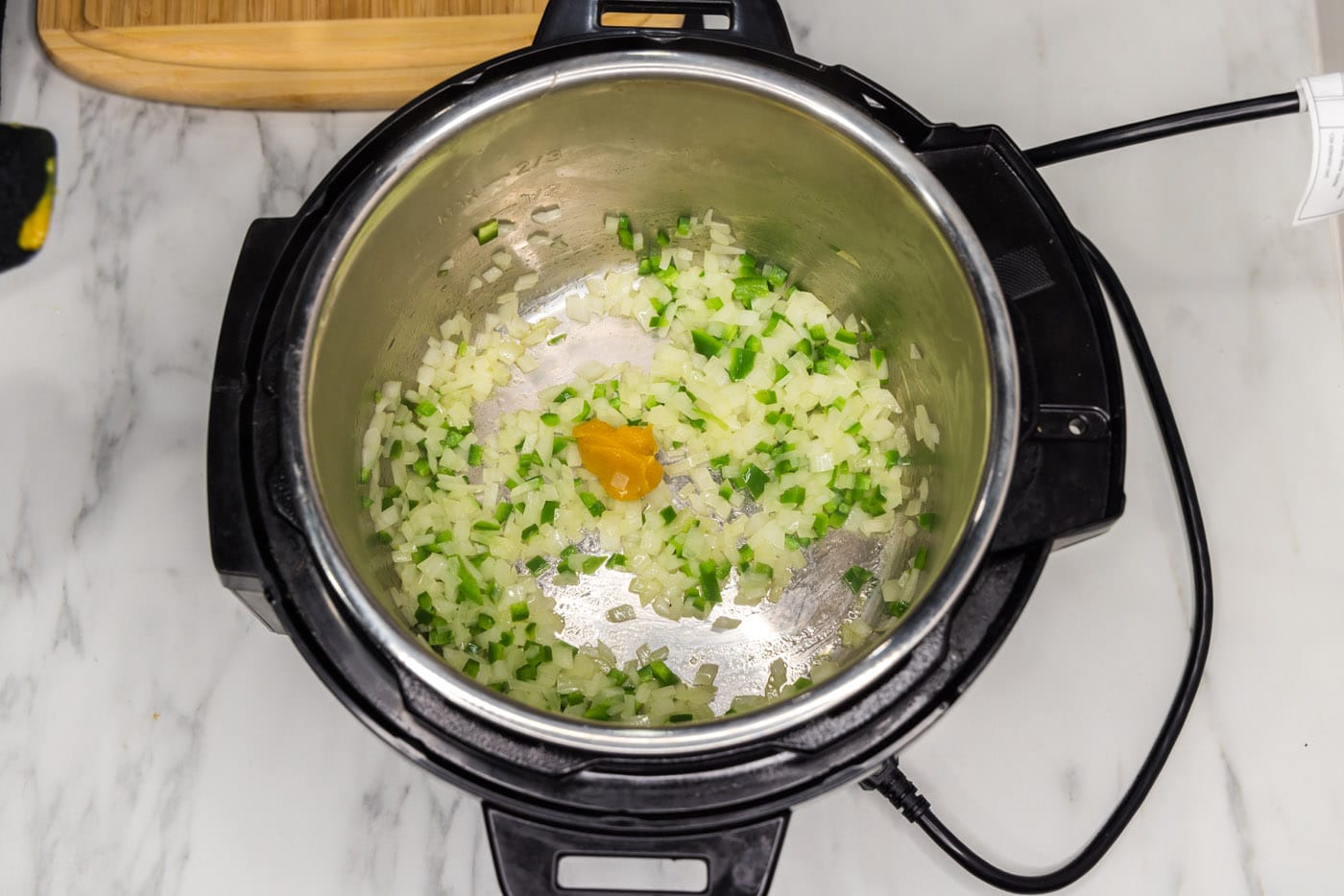 adding beef base to satueed vegetables in an instant pot