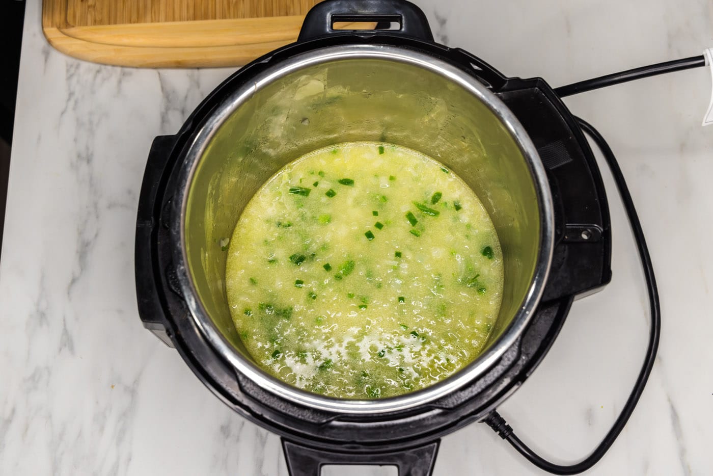 water, chicken base, and vegetables in pressure cooker