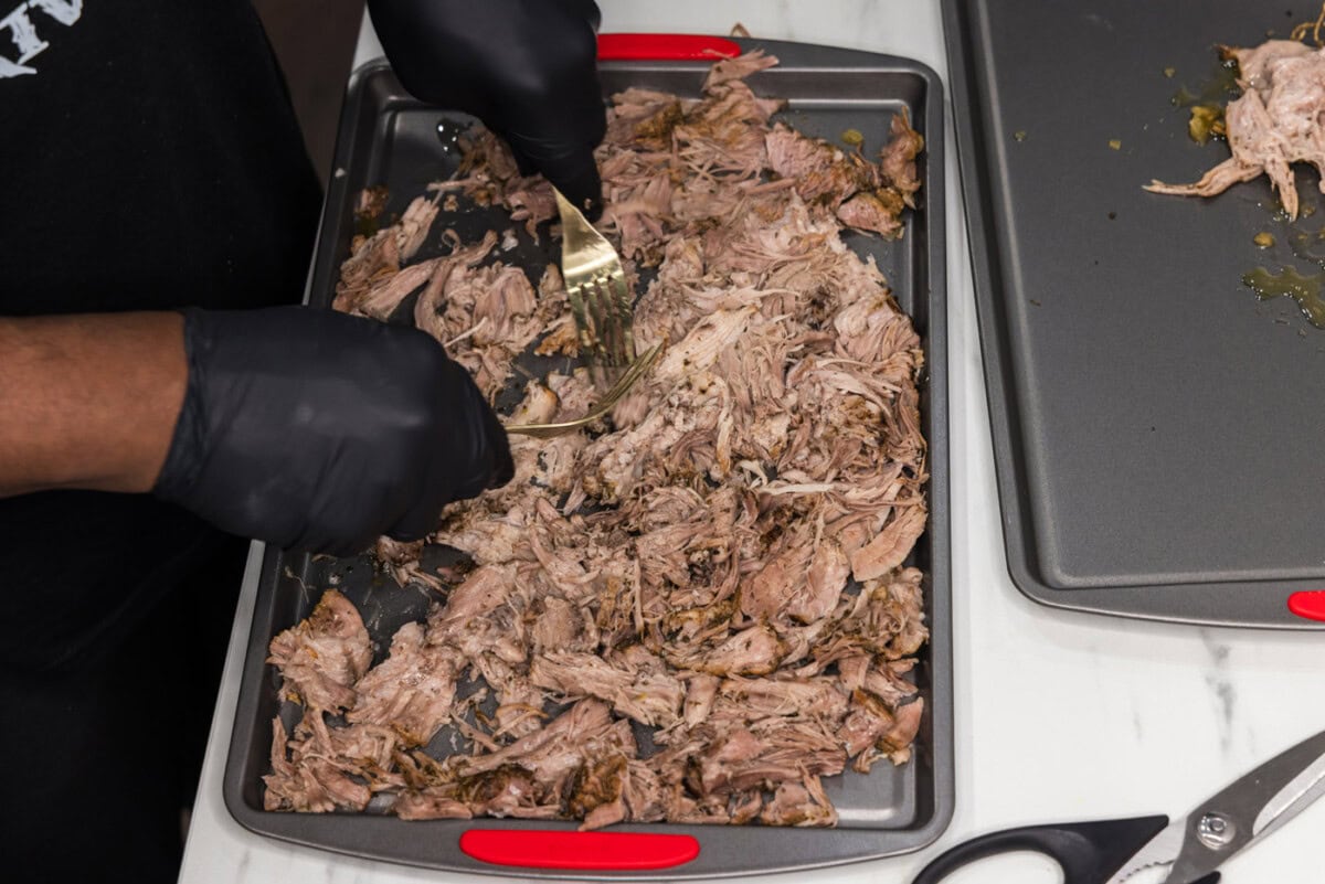 shredding carnitas with forks