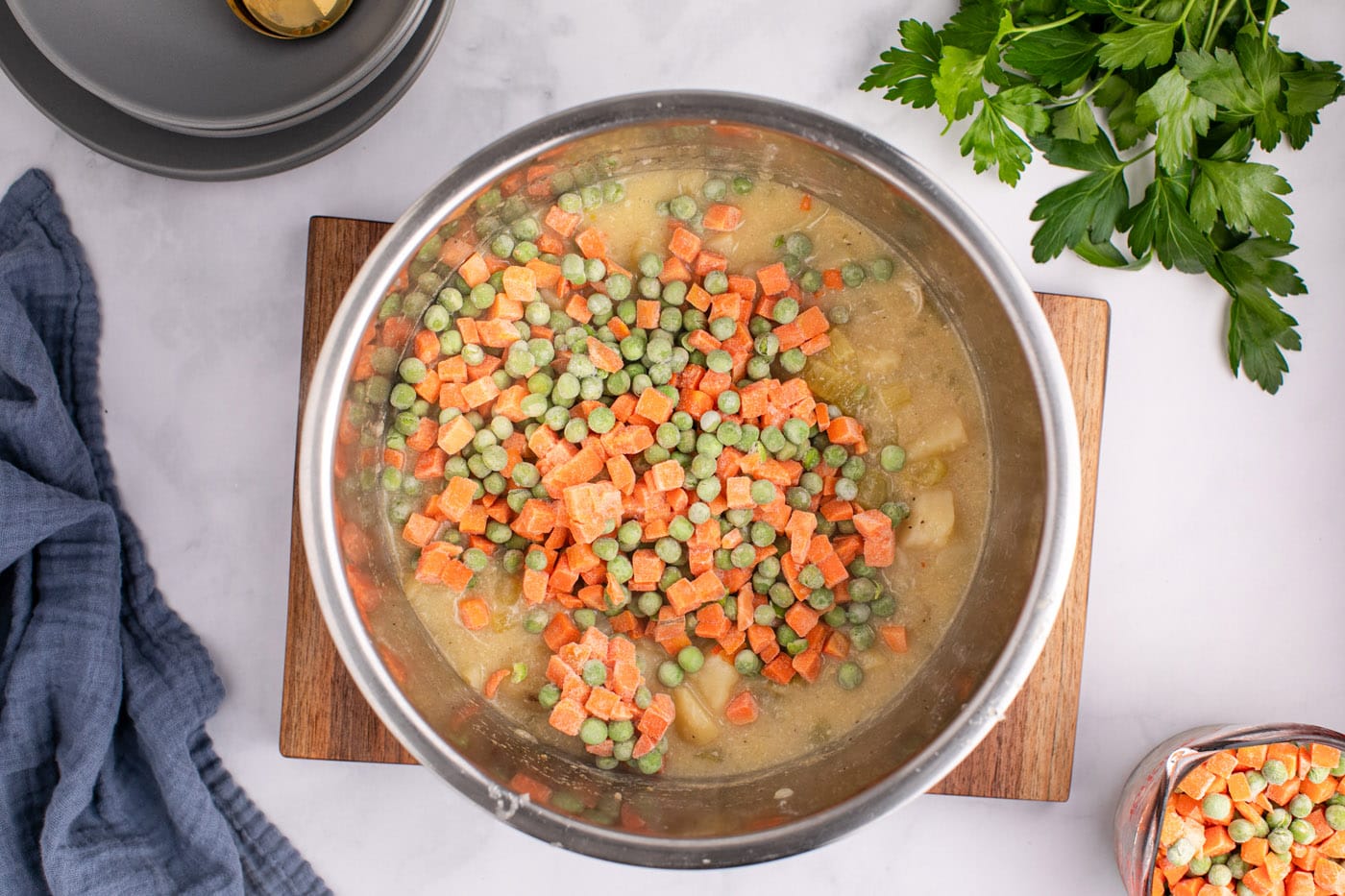 frozen peas and carrots added to chicken pot pie mixture in the instant pot