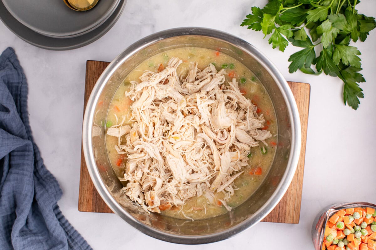 shredded chicken added to pot pie mixture in the pressure cooker