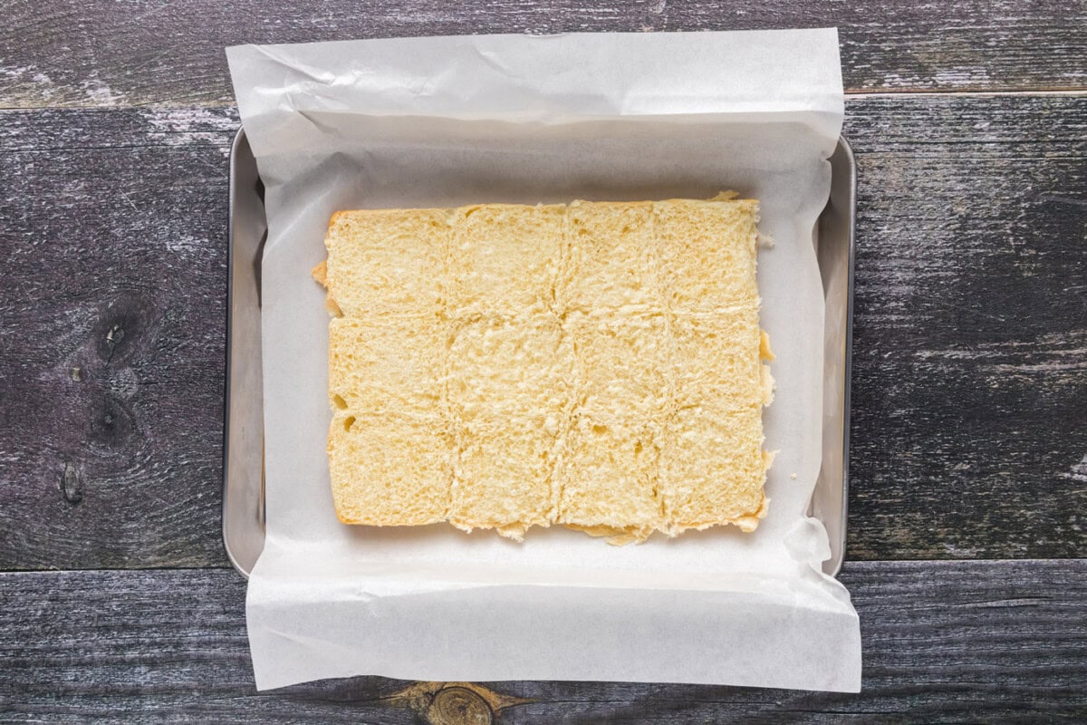 bottom of slider buns in a parchment lined baking sheet