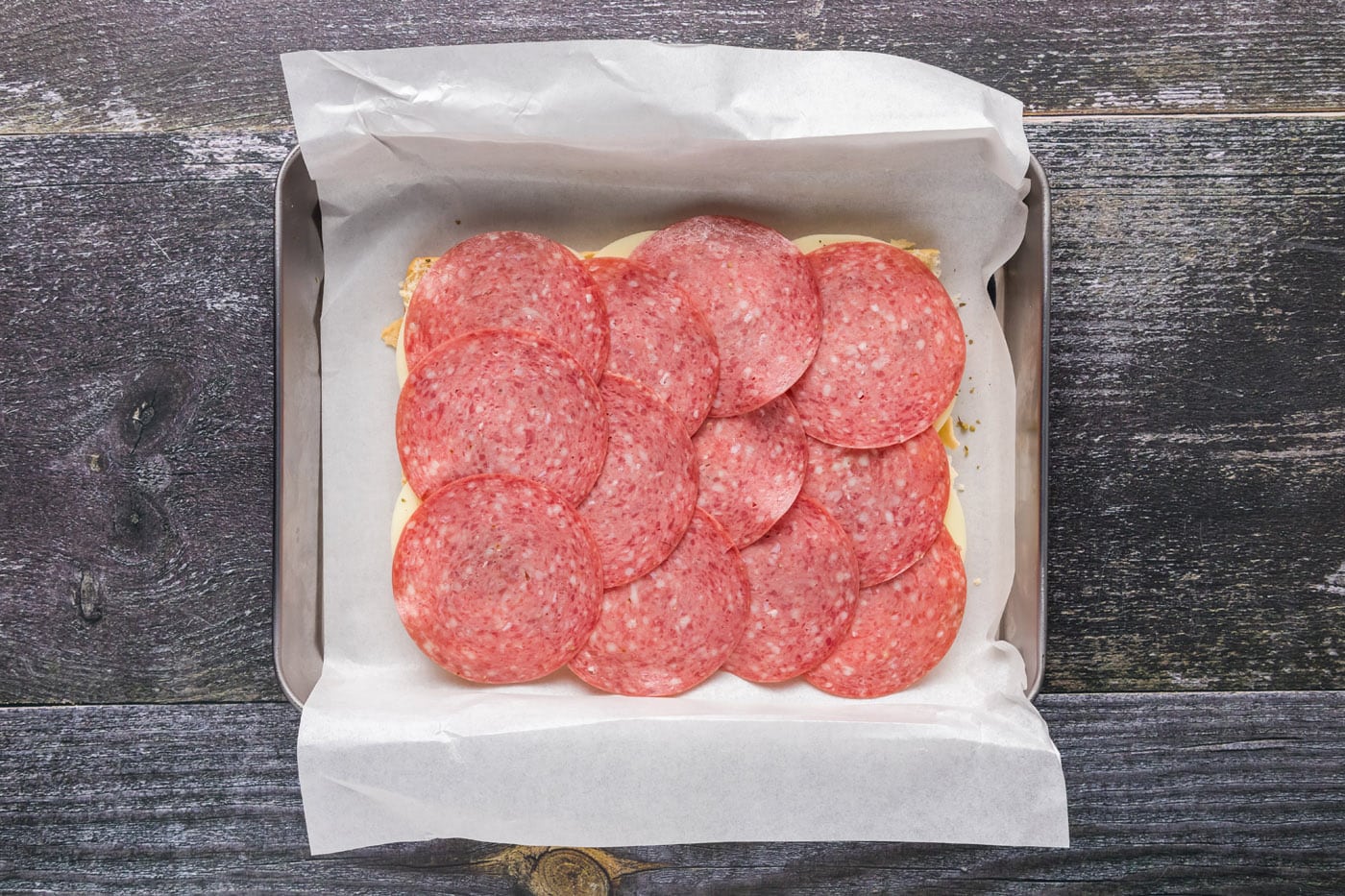layer of salami over provolone sliders